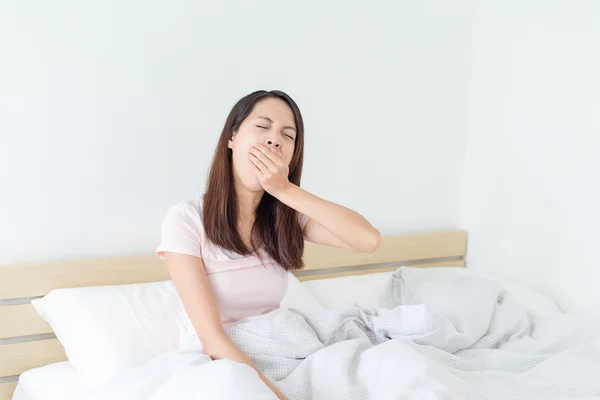 Woman feeling tired on bed — Stock Photo, Image