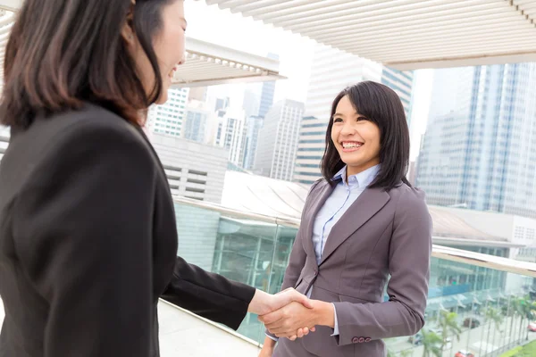 Two asian businesswomen shaking hands — Stock Photo, Image