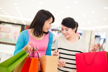 Asyalı genç kadınlar alışveriş torbaları ile
