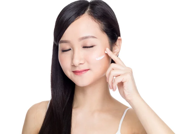 Woman applying cosmetic cream — Stock Photo, Image