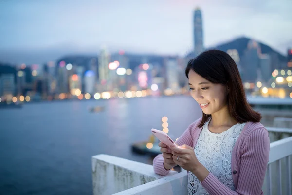 Mulher usando telefone celular à noite — Fotografia de Stock