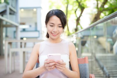 Açık café'de cep telefonu kullanan kadın