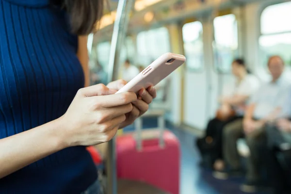 Woman using cellphone inside train compartment — Stock Photo, Image