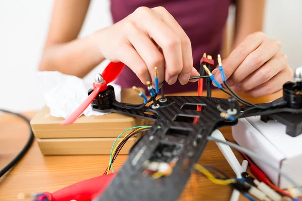 Building of flying drone with connecting cable