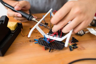 drone onarmak için kaynak kullanan adam