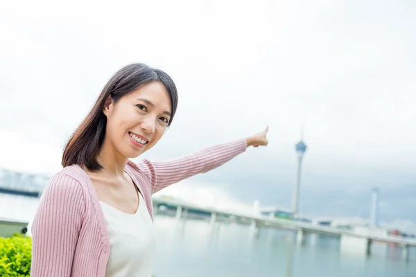 Mulher com o dedo apontando para a torre de Macau — Fotografia de Stock