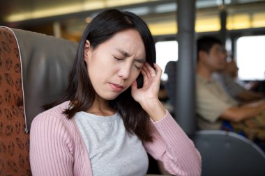 woman suffering from headache on the boat clipart