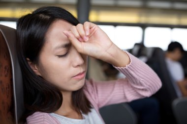 woman suffering from headache on the ferry clipart