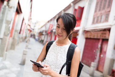 Macau şehirde cep telefonu kullanan kadın