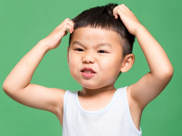 Little boy scratching his head — Stock Photo, Image