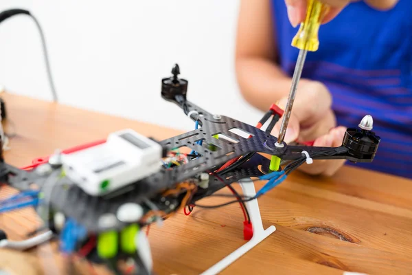 man doing repair of drone