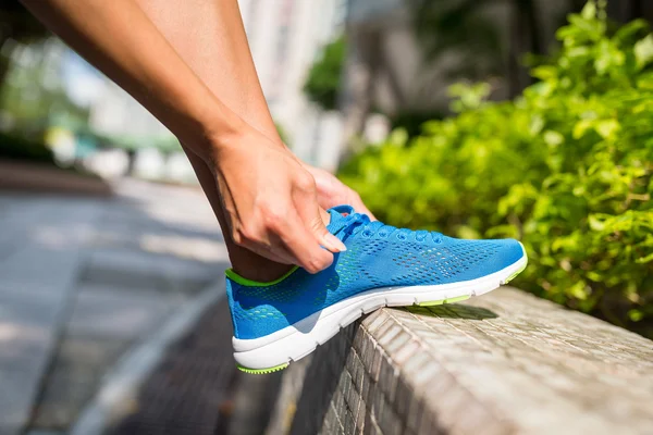 Frau bindet Schnürsenkel zum Joggen — Stockfoto