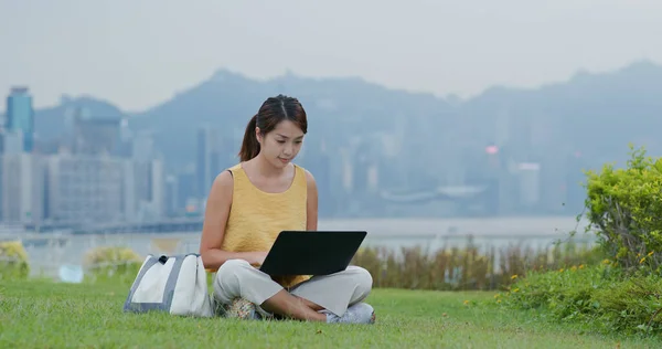 Woman work on laptop computer at park