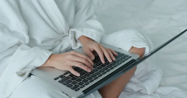 Woman work on laptop computer at hotel room at quarantine period