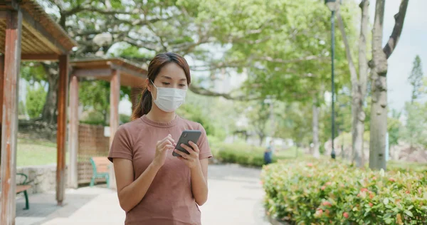 Woman wear face mask and use of cellphone at outdoor