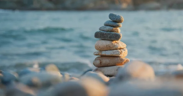 Balanced Pebble stone at beach in sunset time