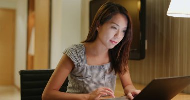 Kadın geceleri dizüstü bilgisayarda çalışıyor.