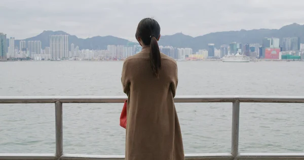 Woman look at the sea in city of Hong Kong