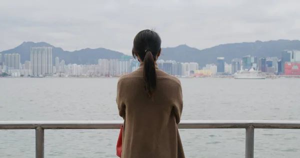 Woman look at the sea in city of Hong Kong