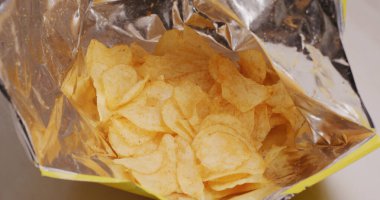 Patates cipsini pakete koy. 