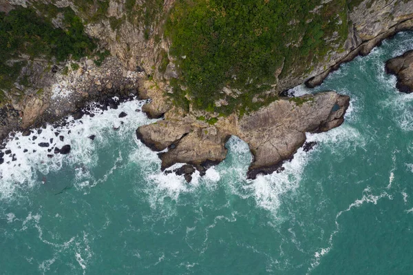 Top down view of the sea crash on rock