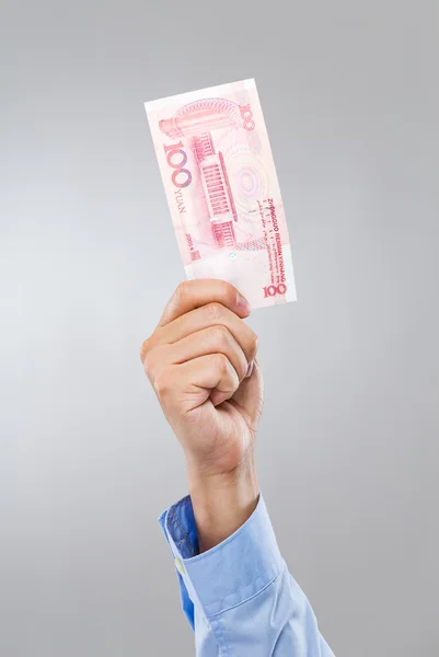 Empresario agarre de la mano con cien RMB — Foto de Stock