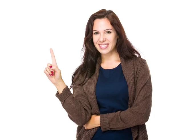 Brünette Frau mit erhobenem Finger — Stockfoto