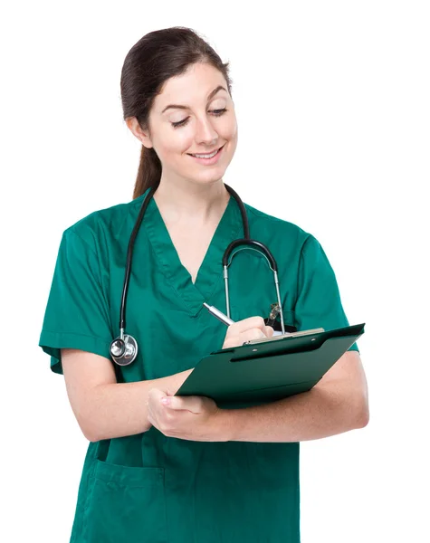 Female doctor write on clipboard Stock Picture