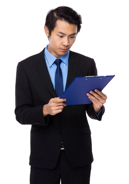 Businessman looking on clipboard — Stock Photo, Image