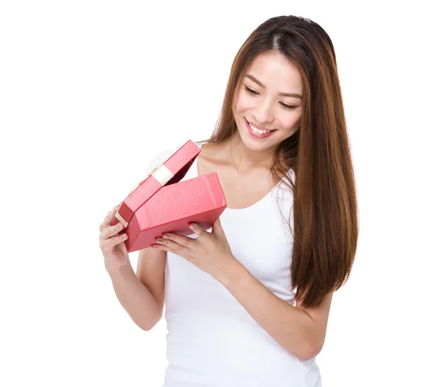 Woman opens red gift box — Stock Photo, Image