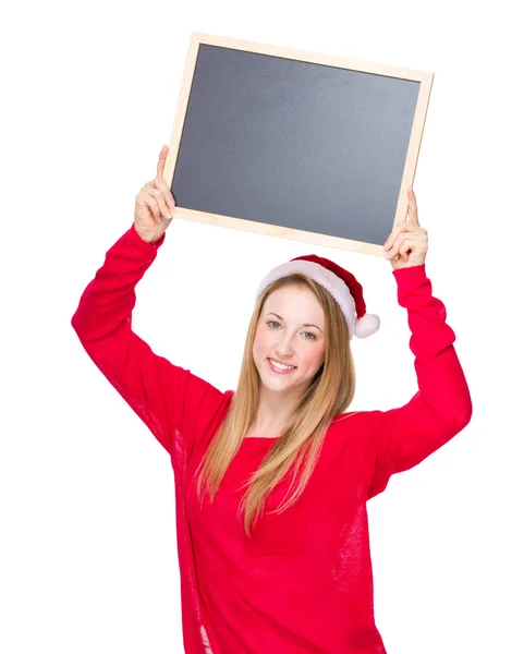 Woman in Christmas hat holding chalkboard — Stock Photo, Image
