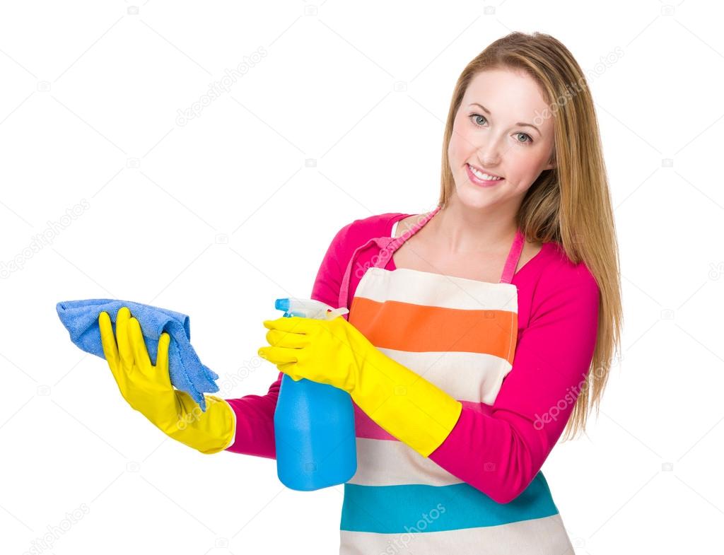 Housewife cleaning with rag and spray