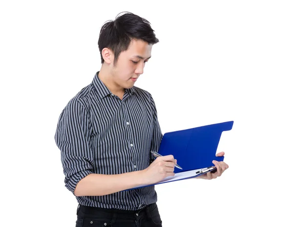 Businessman writes on clipboard — Stock Photo, Image