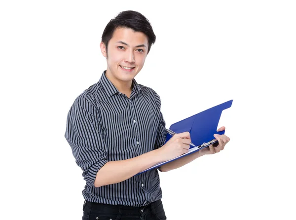 Businessman writes on clipboard — Stock Photo, Image