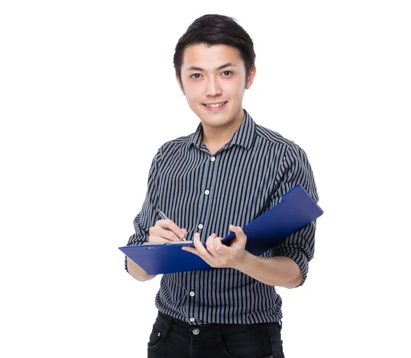 Businessman writes on clipboard — Stock Photo, Image