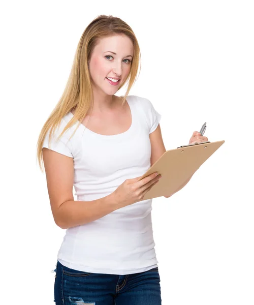 Woman writes on clipboard Royalty Free Stock Images