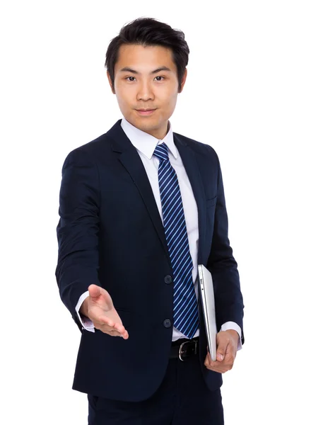 Businessman with laptop gives hand — Stock Photo, Image