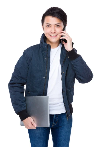 Uomo con laptop che parla al telefono — Foto Stock