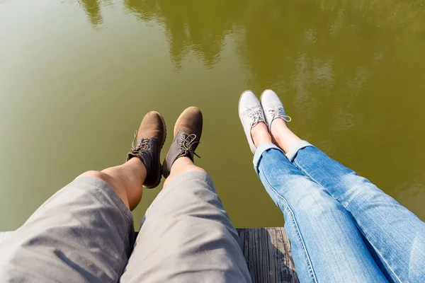 Couple's legs with lake