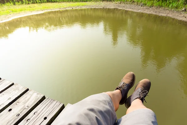 Man's legs with lake