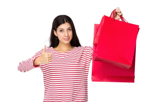 Kadın alışveriş torbaları ve başparmak ile — Stok fotoğraf