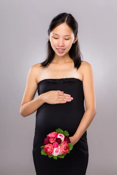 Pregnant woman hold with flower — Stock Photo, Image