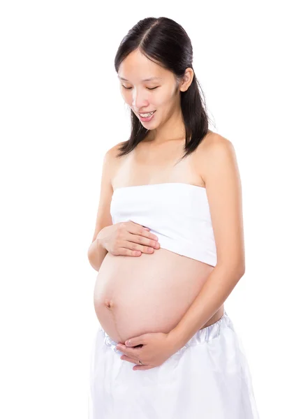 Pregnant woman look at her tummy — Stock Photo, Image