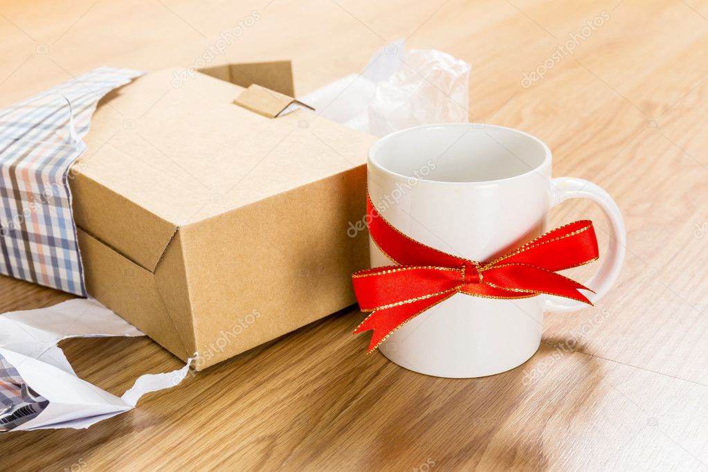 White cup with red bow