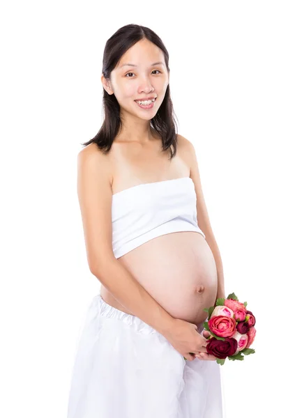 Κρατήστε έγκυος γυναίκα με λουλούδι — Φωτογραφία Αρχείου