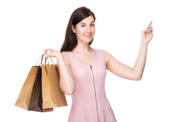 Mulher com sacos de compras e dedo aponte para cima — Fotografia de Stock