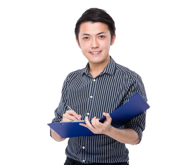 Businessman writes on clipboard — Stock Photo, Image