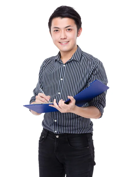 Businessman writes on clipboard — Stock Photo, Image