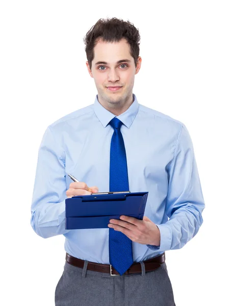 Businessman writes on clipboard — Stock Photo, Image