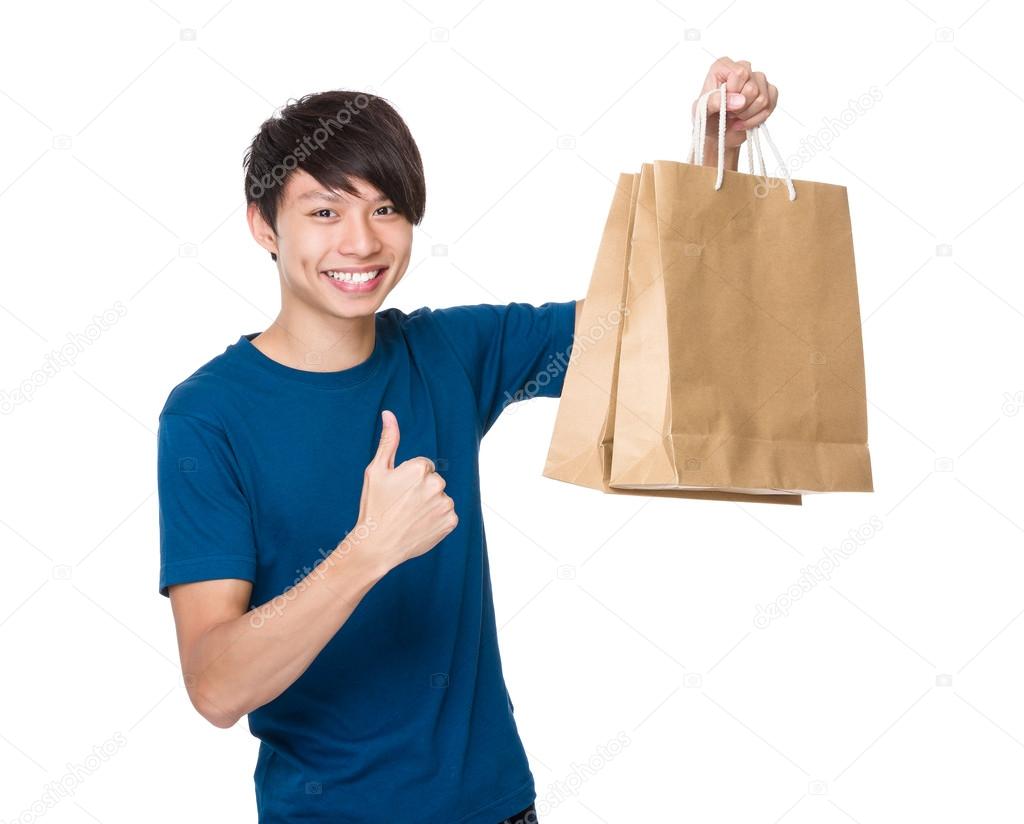 Man with shopping bags and thumb up